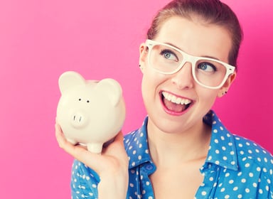 young woman with piggy bank_GettyImages-576755378