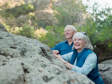 older couple near a boulder_GettyImages-84120556