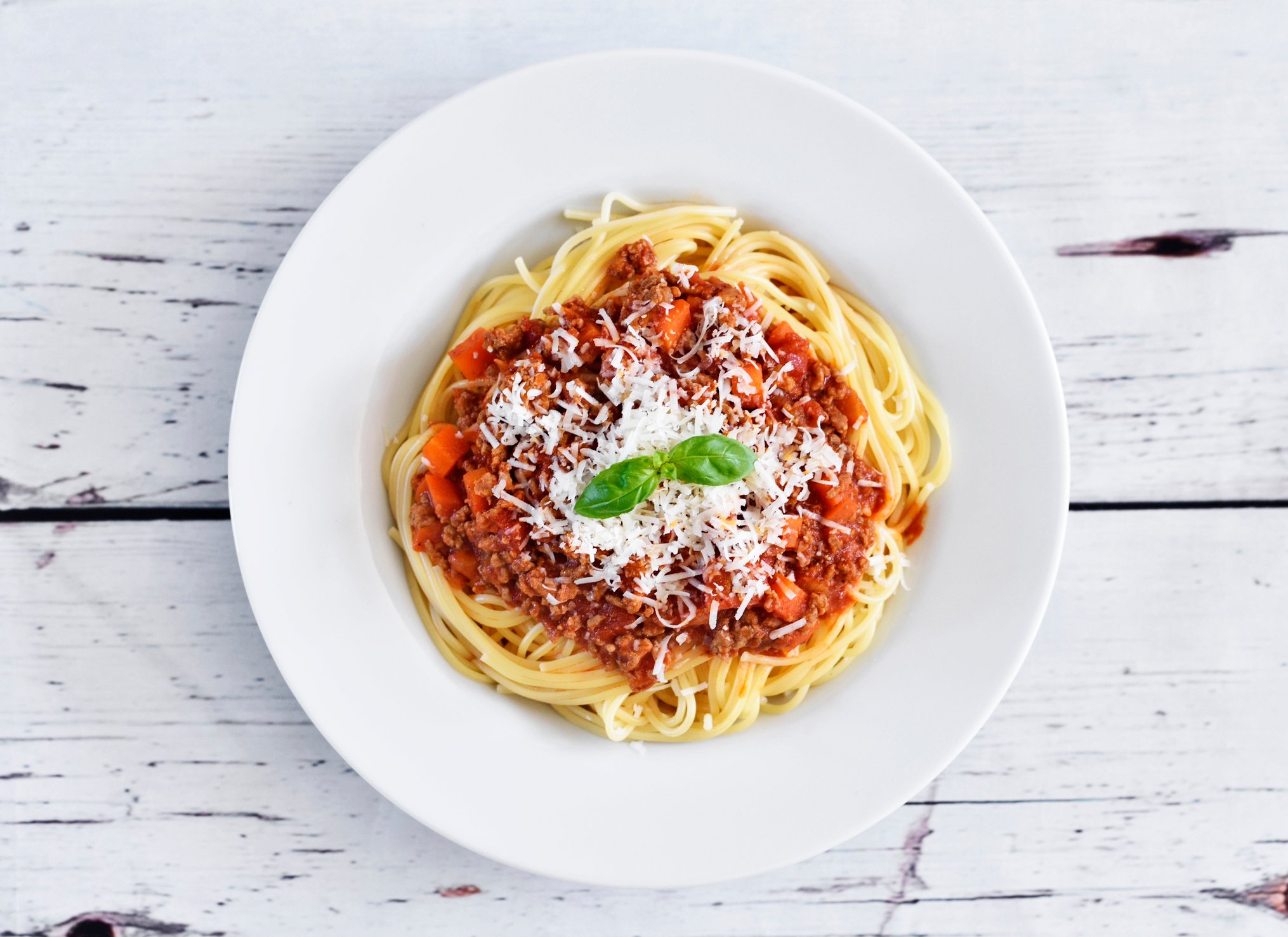 A bowl of pasta with red sauce viewed from above