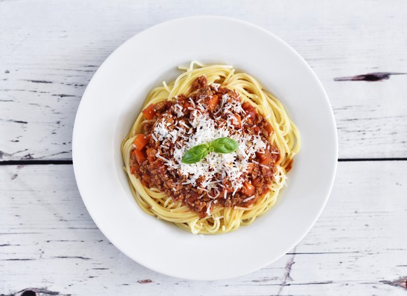 A bowl of pasta with red sauce viewed from above