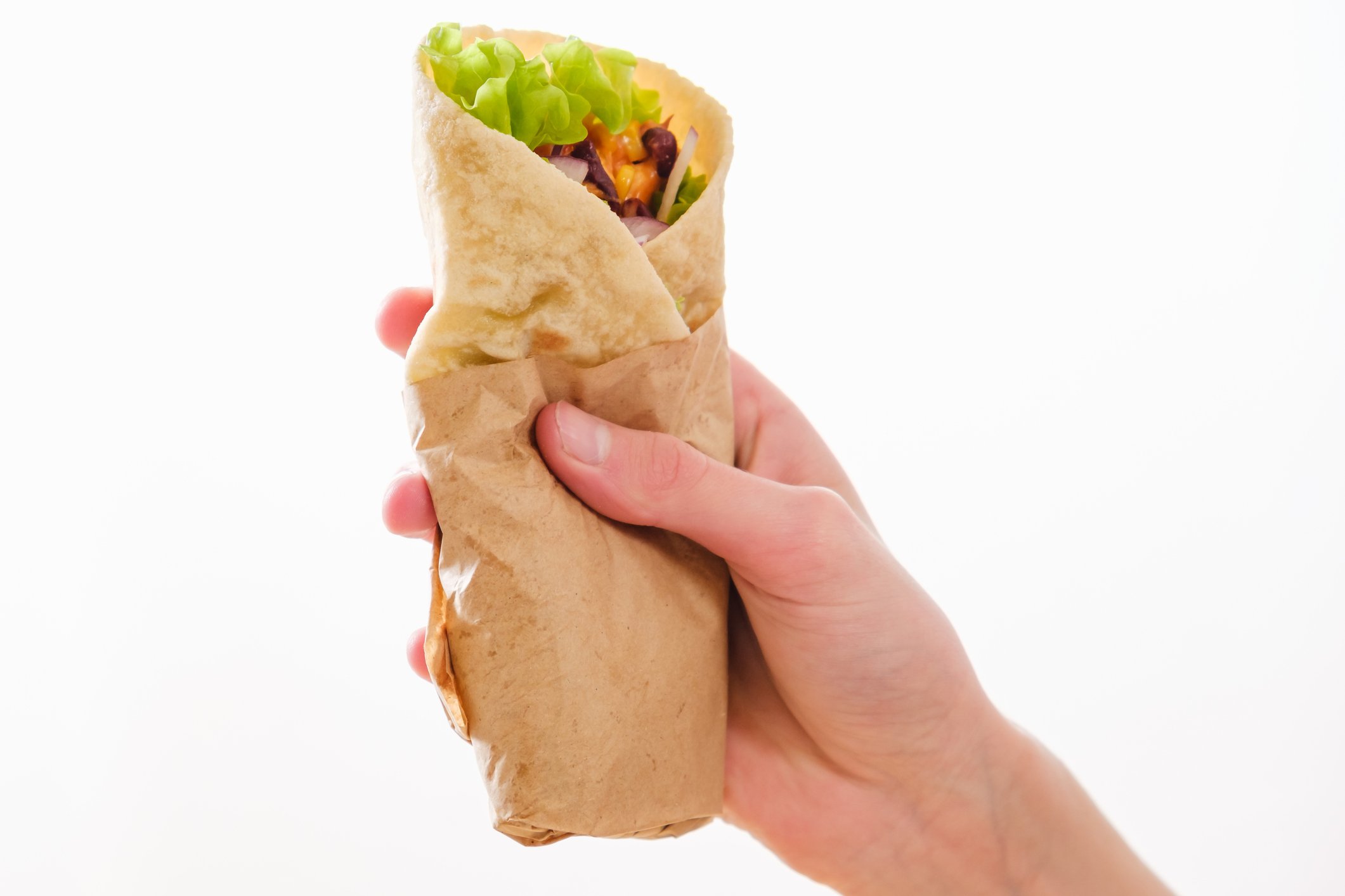A hand holding a burrito