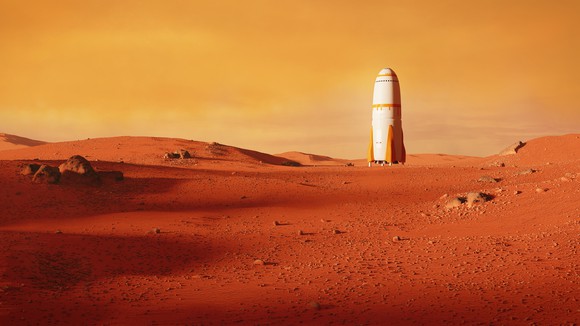 A rocket sitting on a plain on Mars.
