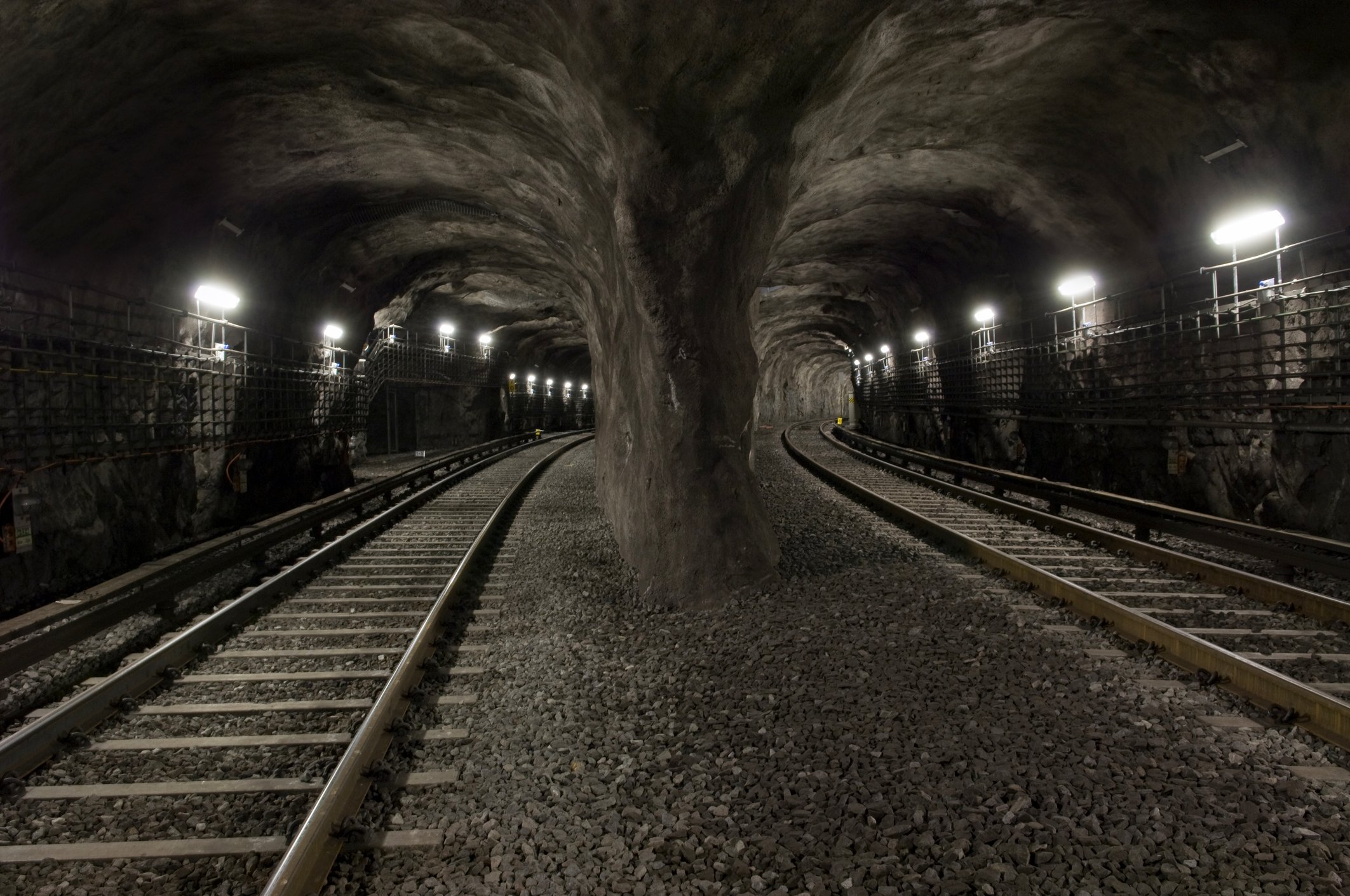 Two sets of tracks run down parallel mining tunnels.