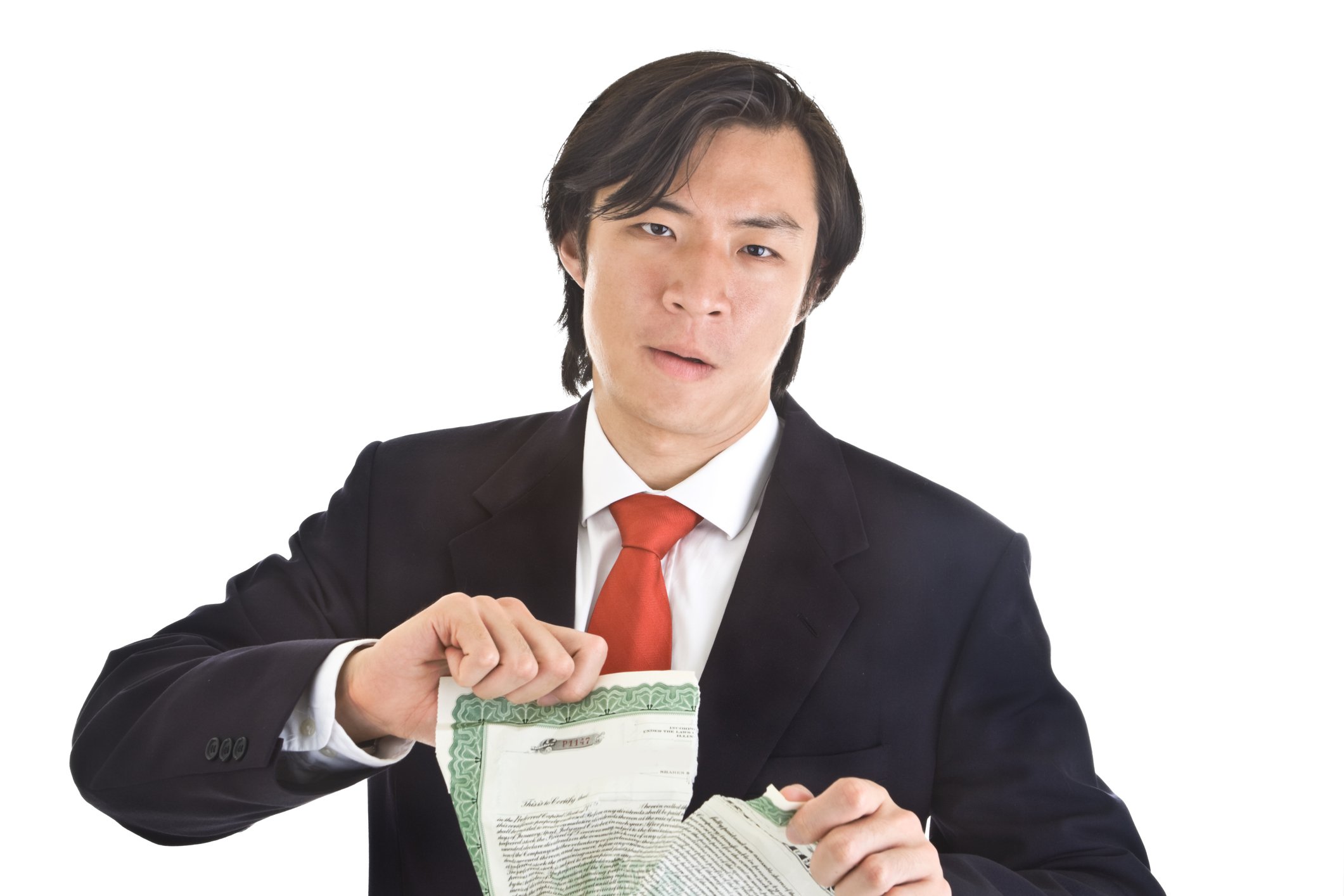 Man splitting a stock certificate in half.