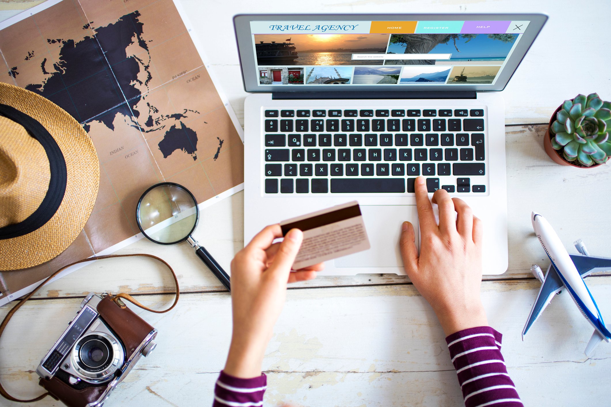 A woman using a laptop to plan her vacation.