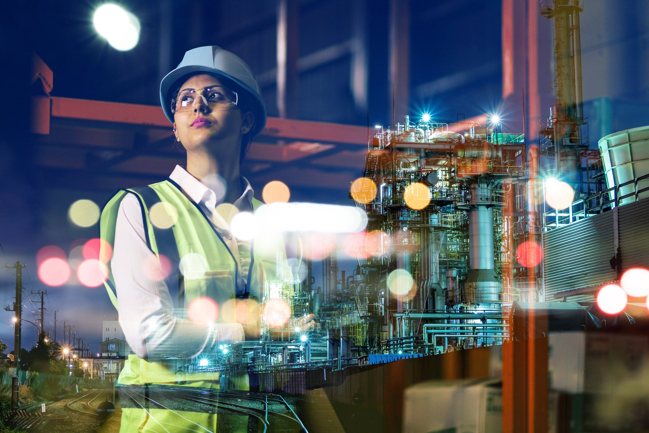 Woman wearing hardhat in industrial setting