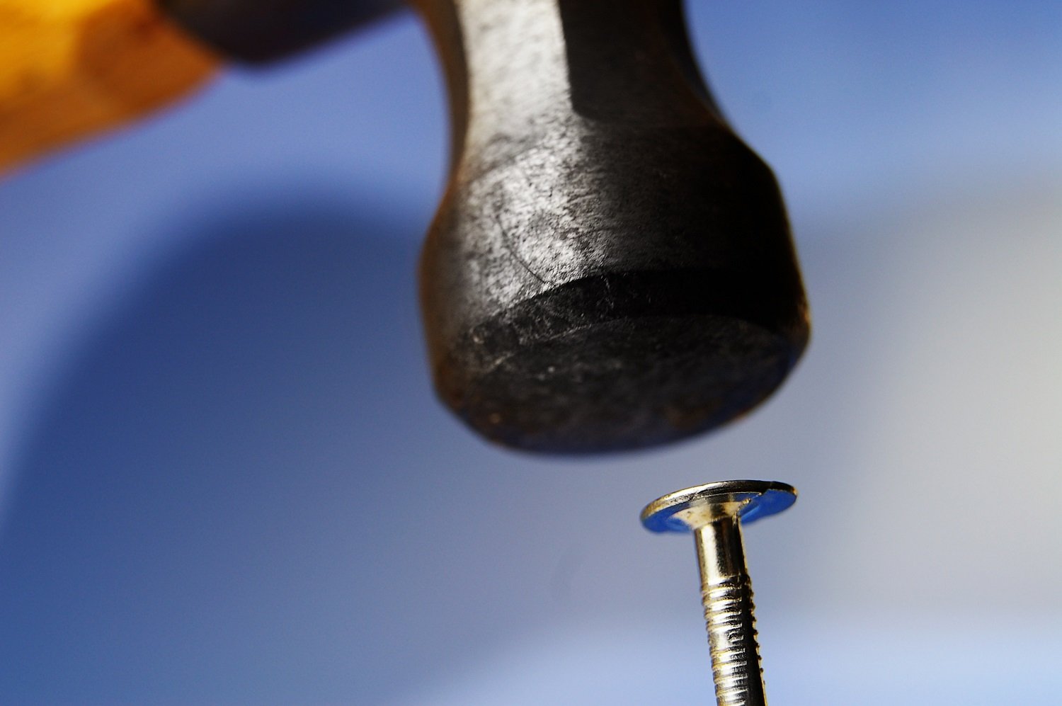 A hammer hitting a nail.