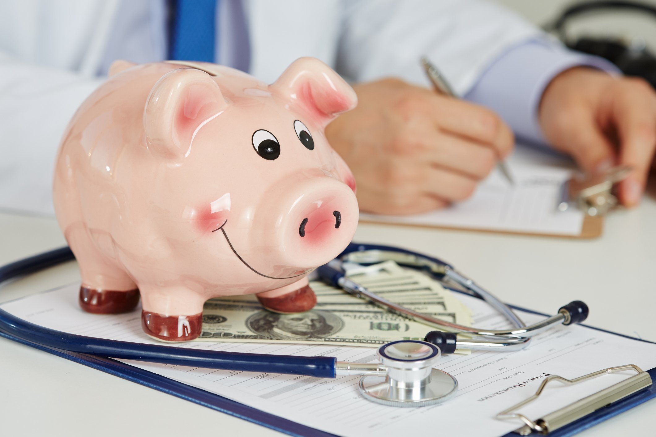 A piggy bank and a doctor's stethoscope