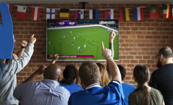 Soccer fans watch a game on TV.