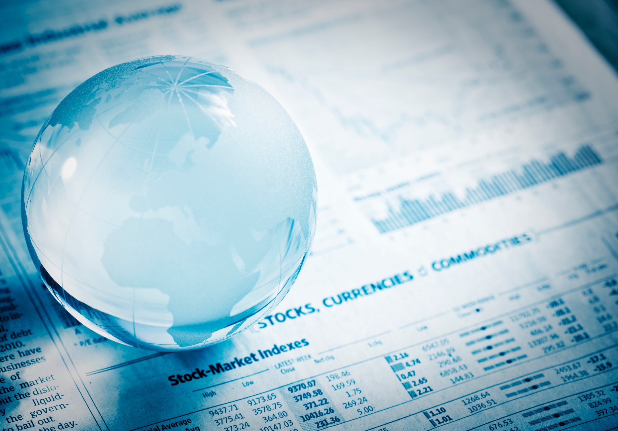 A magnifying glass over financial papers
