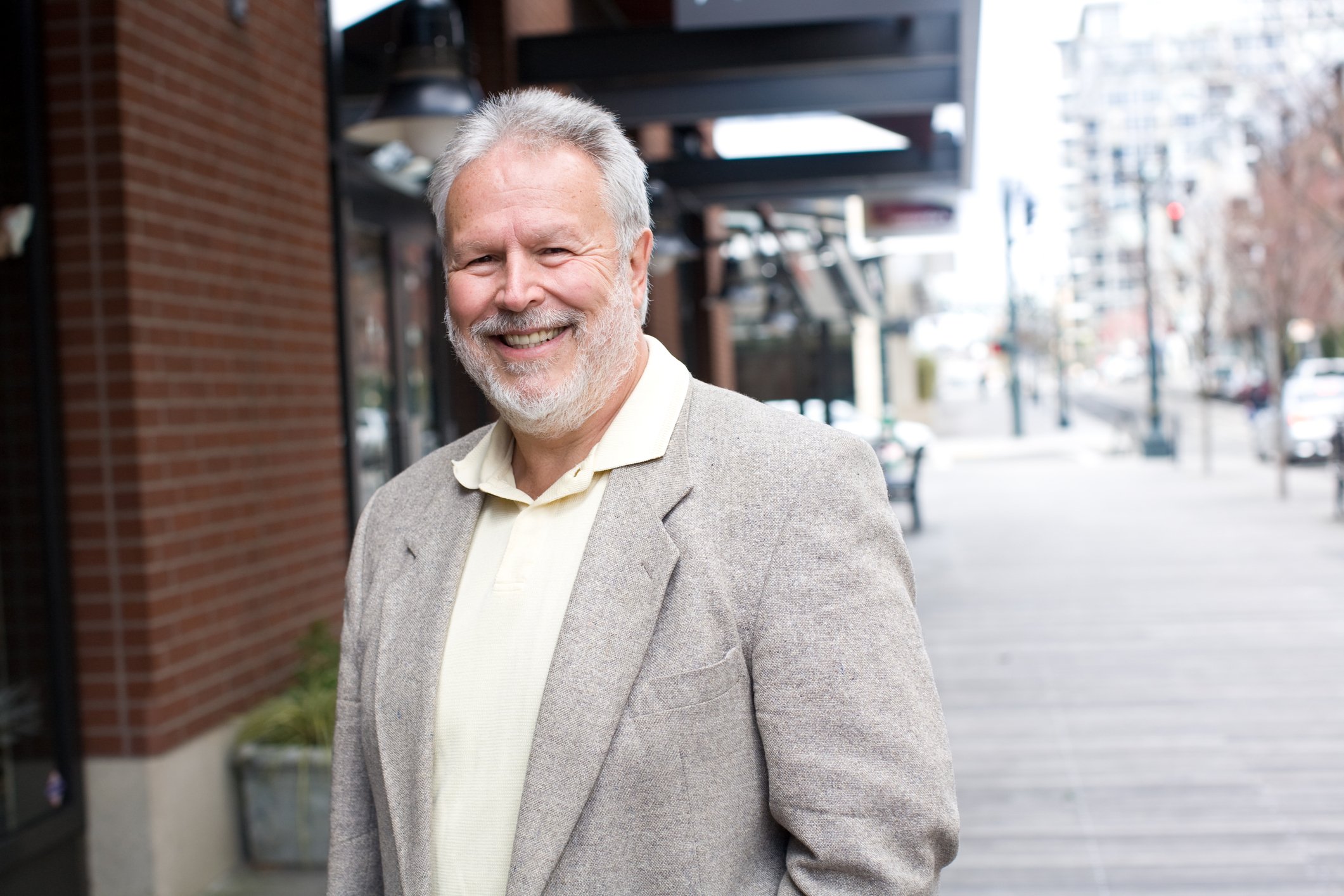 A smiling senior man on the street.