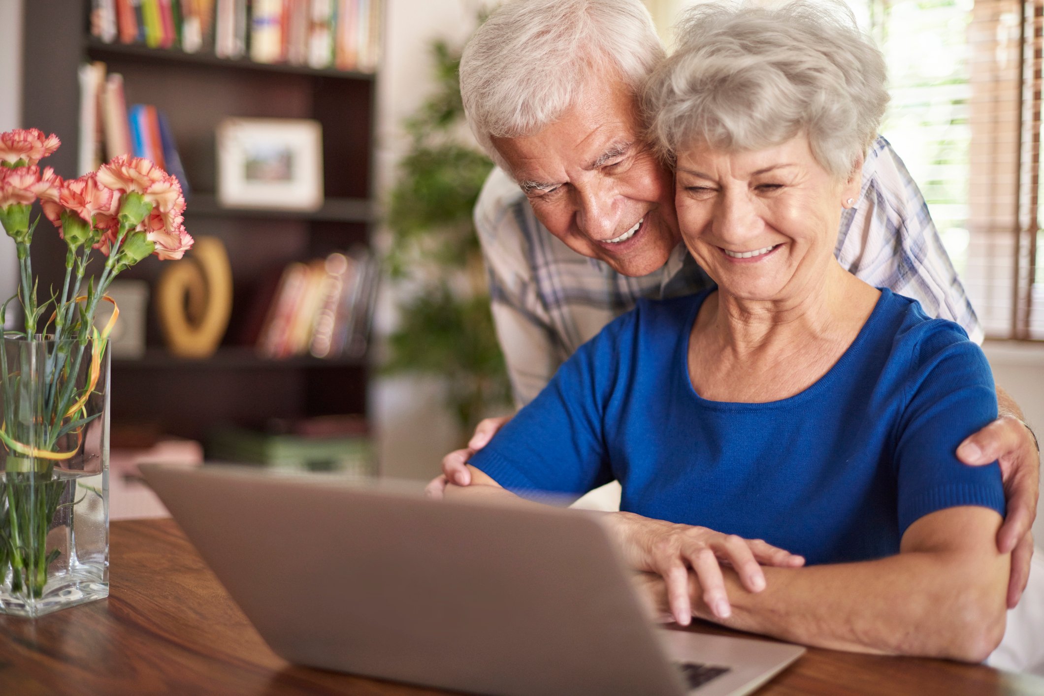 Older man and woman looking at laptop