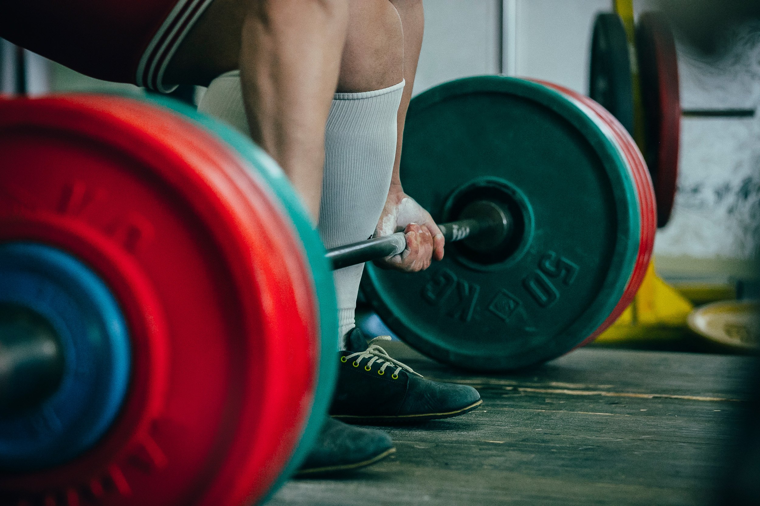 Someone lifting a very heavy barbell