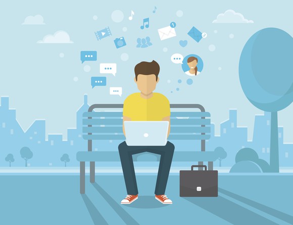 A cartoon image of a man on his computer with social media icons whirling around him.