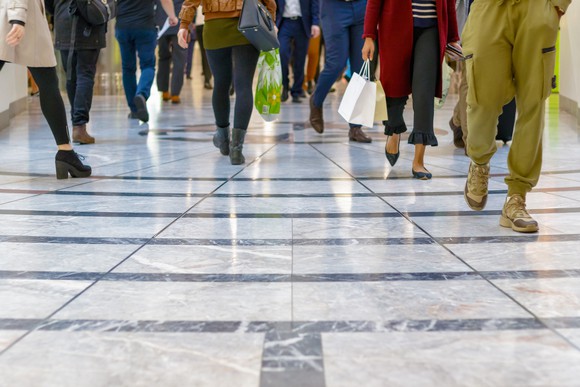 People walking in a mall with a glossy floor