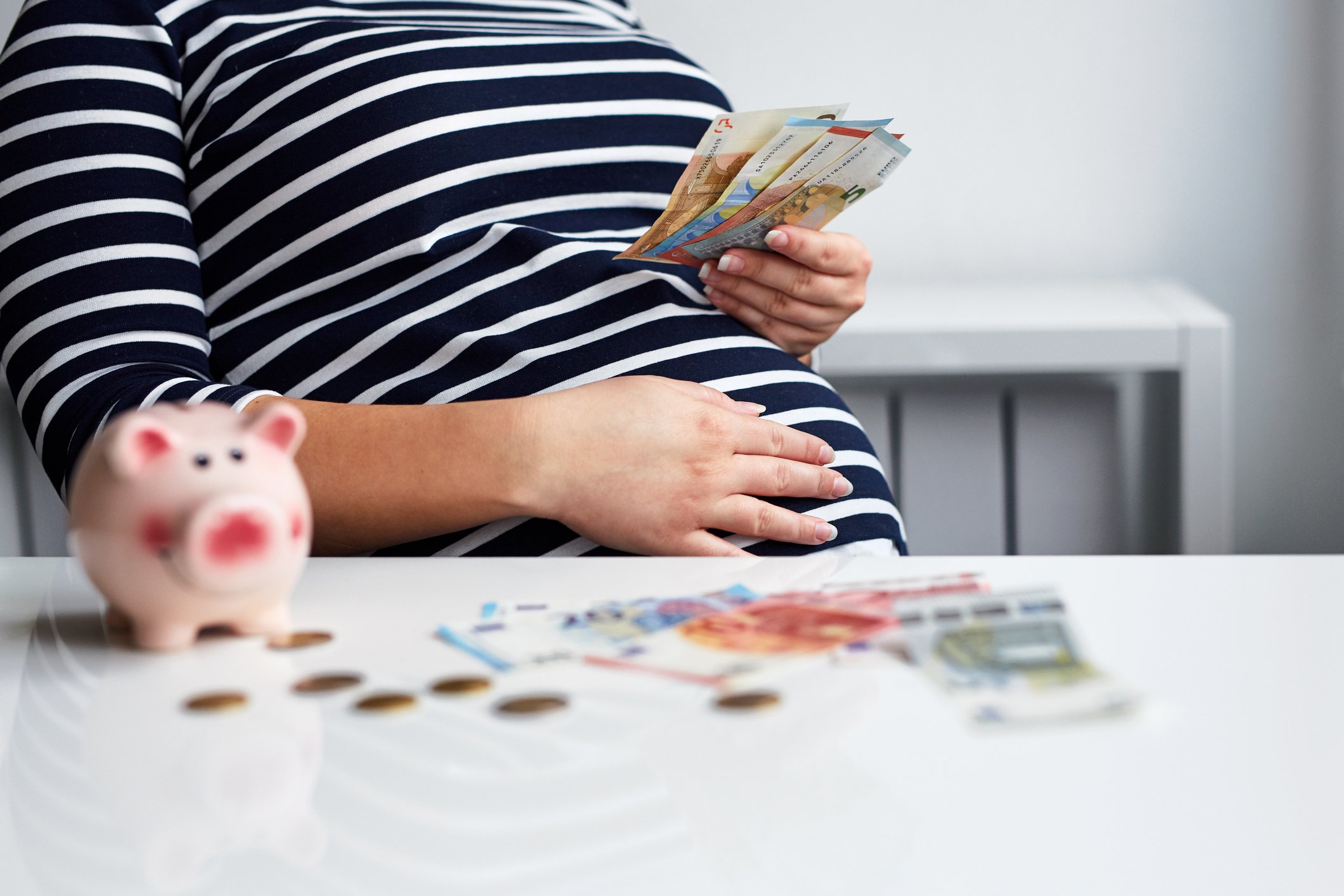 Pregnant woman counts money