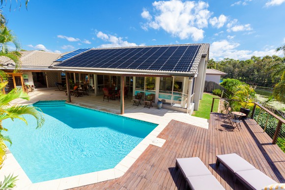 Solar panels on a poolside cabana's rooftop