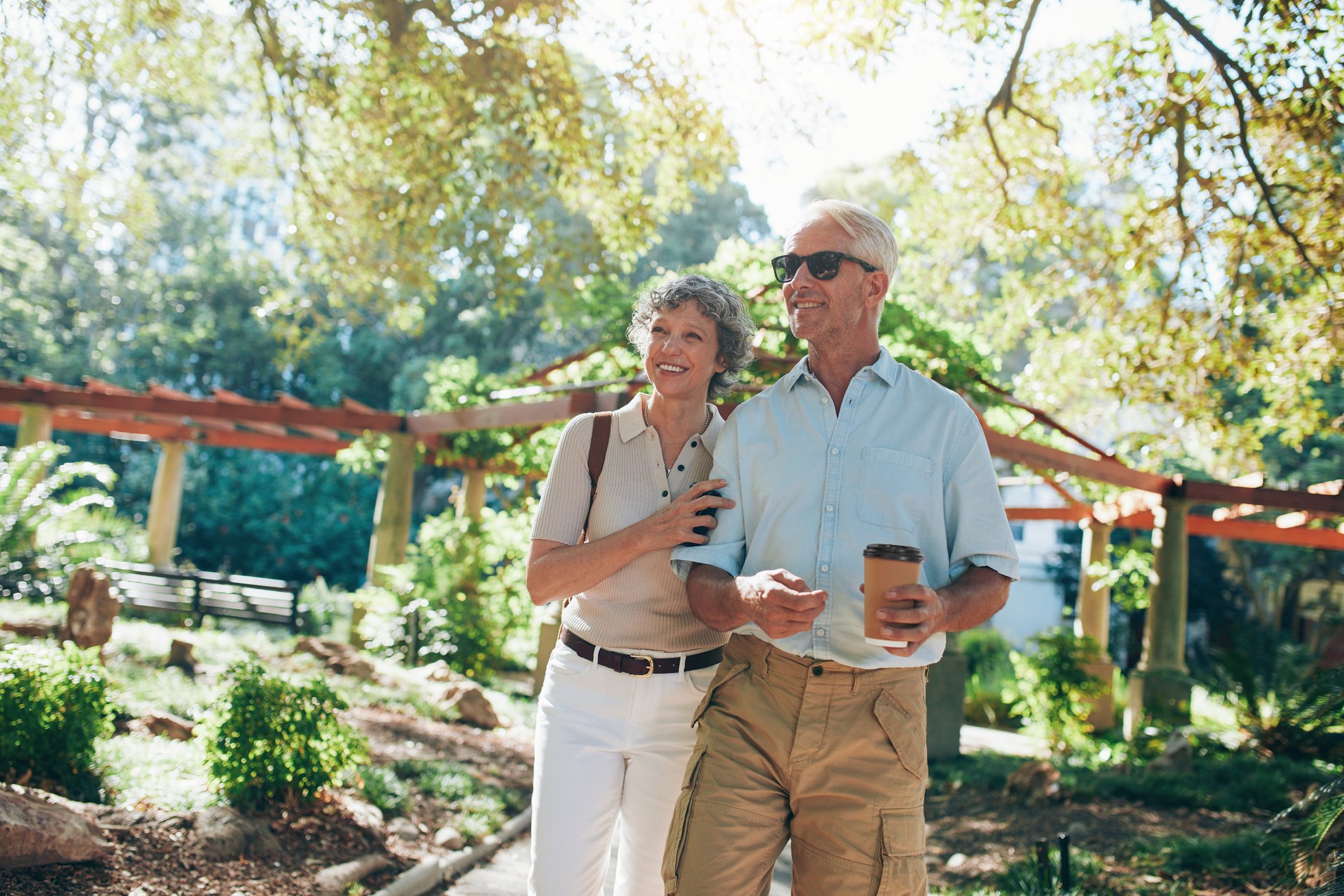 Senior man and woman walking in nature.