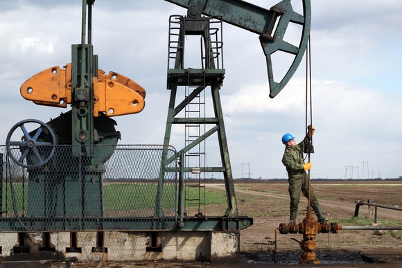 Picture of worker at oil pumpjack