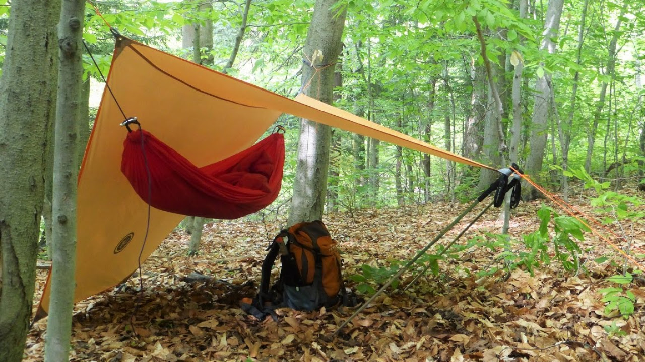 UST Brands tarp shelter and backpack at campsite
