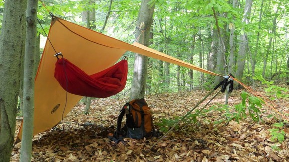 UST Brands tarp shelter and backpack at campsite