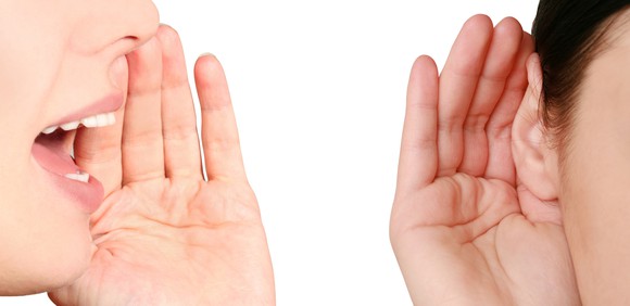 One person whispering to another