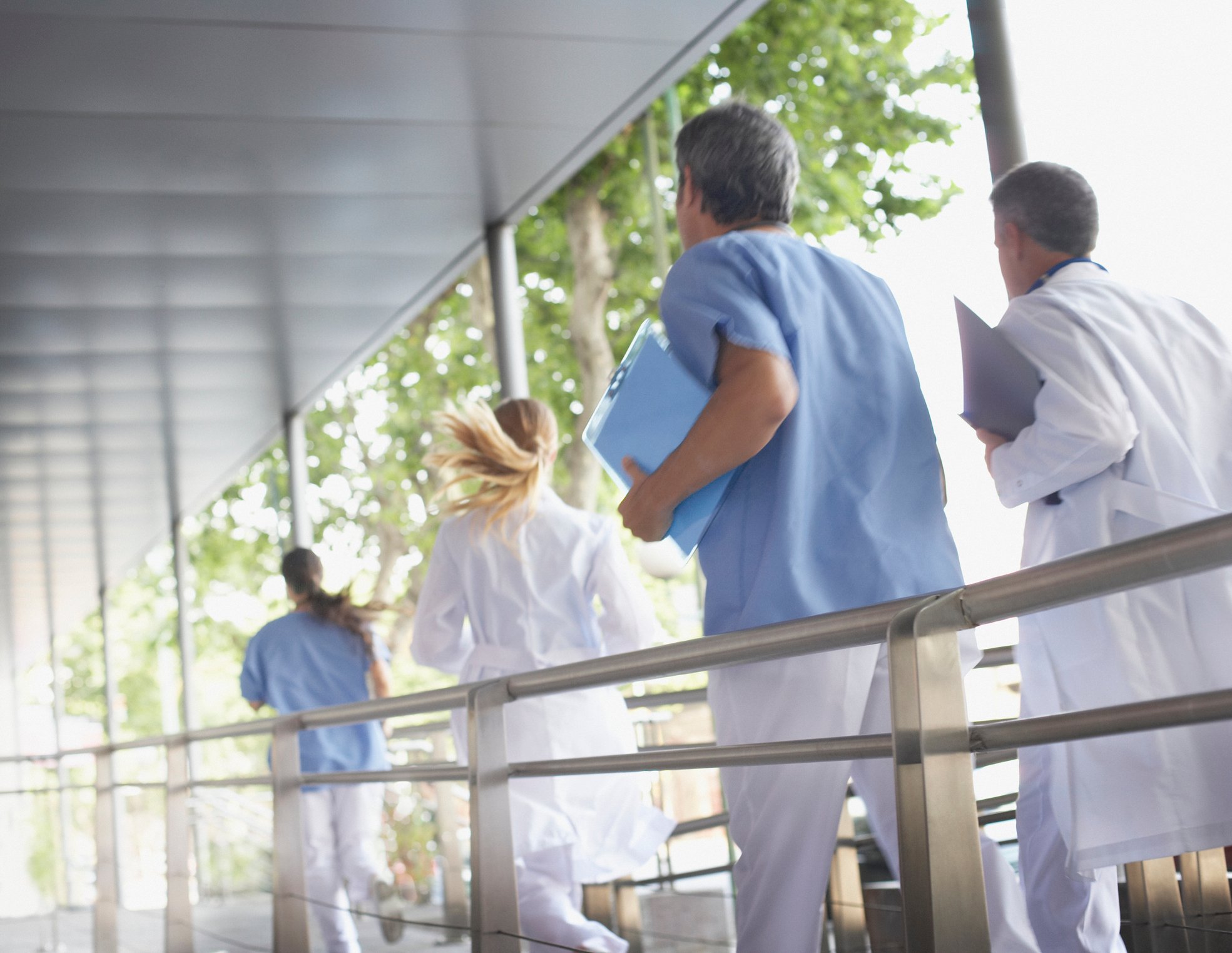Healthcare providers racing down a corridor.