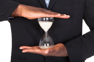 man holding hour glass time