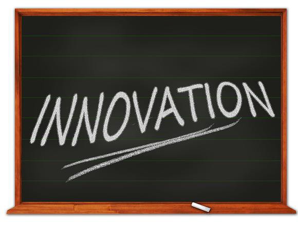 The word "innovation" written on a chalkboard. 