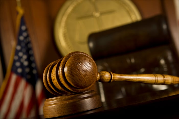Judges chair inside courtroom with gavel on bench. 