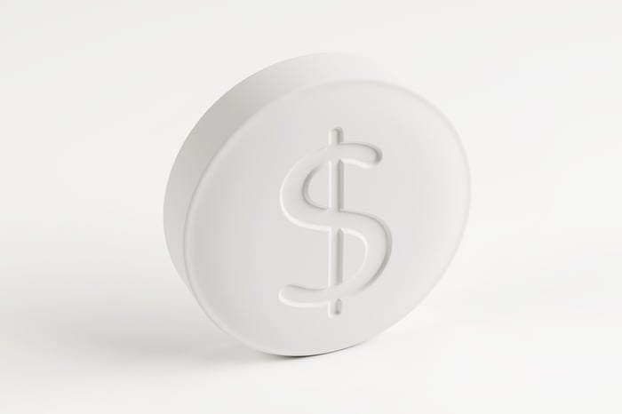 Pill with dollar sign engraved on it. 