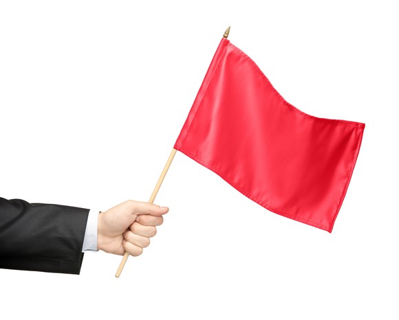 Hand holding a red flag.