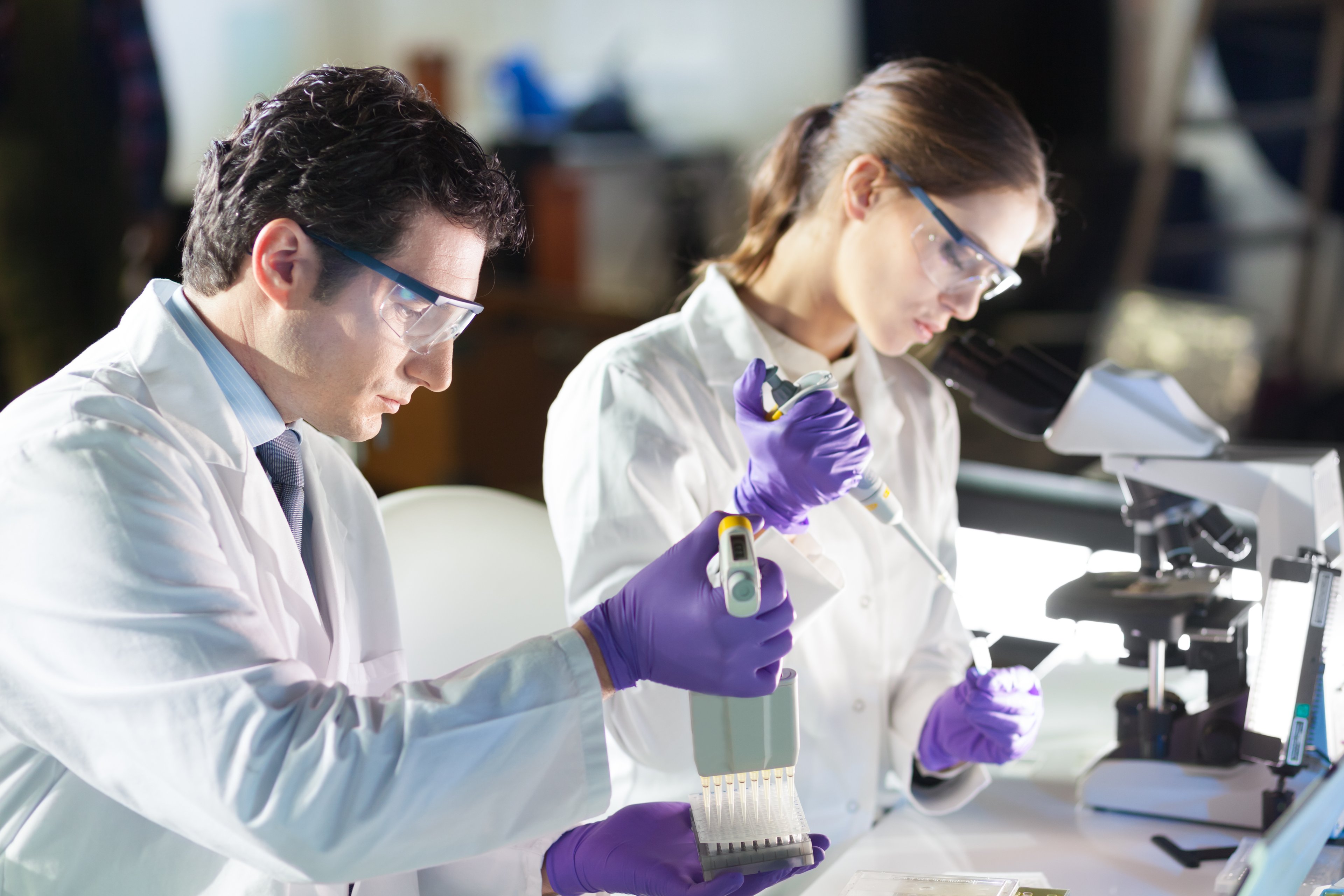 Scientists looking at test tubes