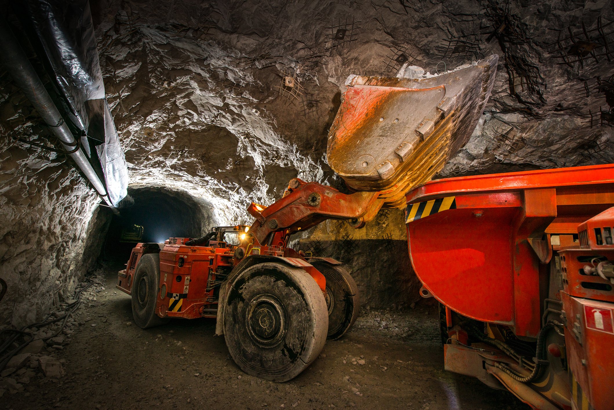 Underground mining equipment excavating minerals from a mine. 