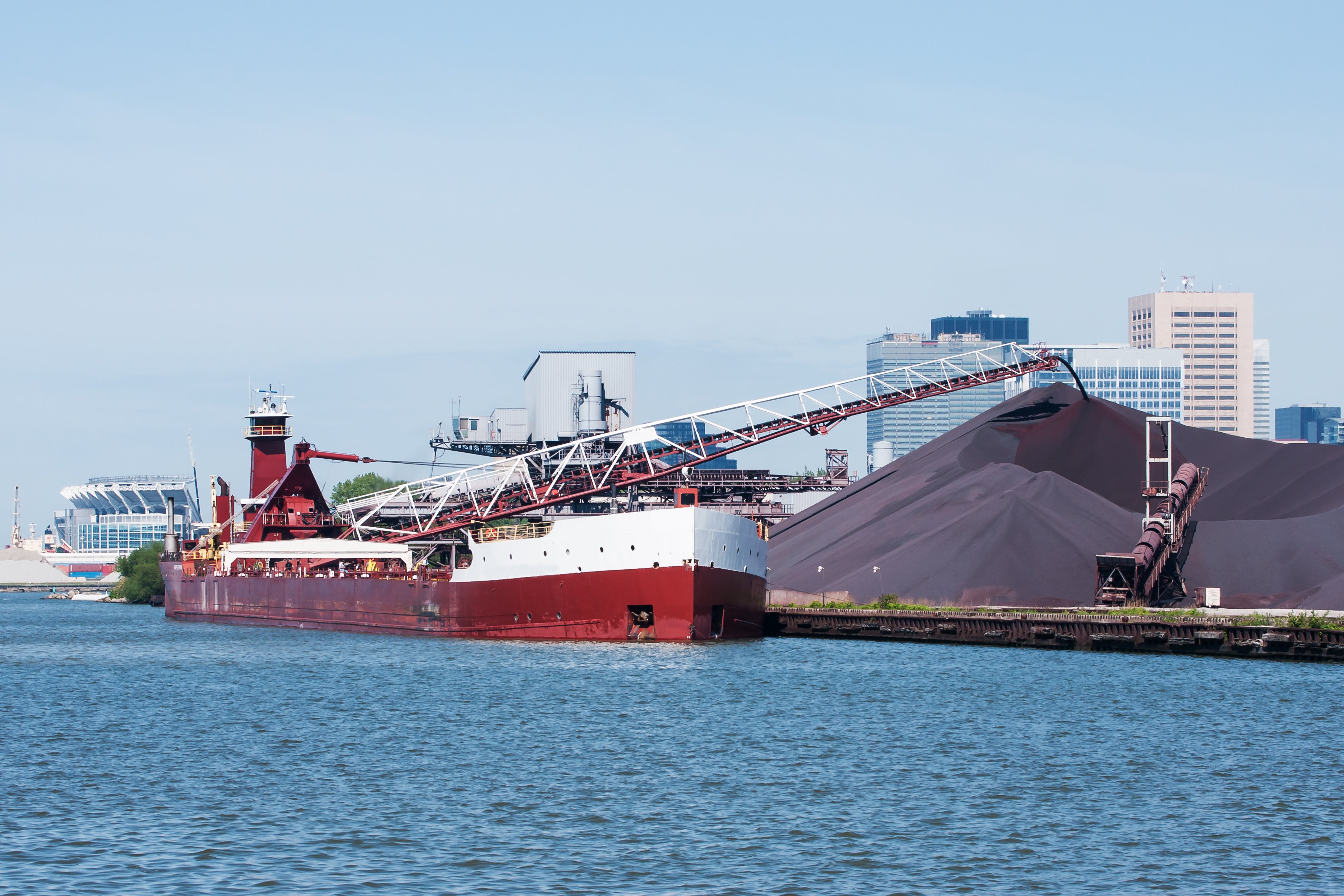 Ship unloading iron ore cargo.