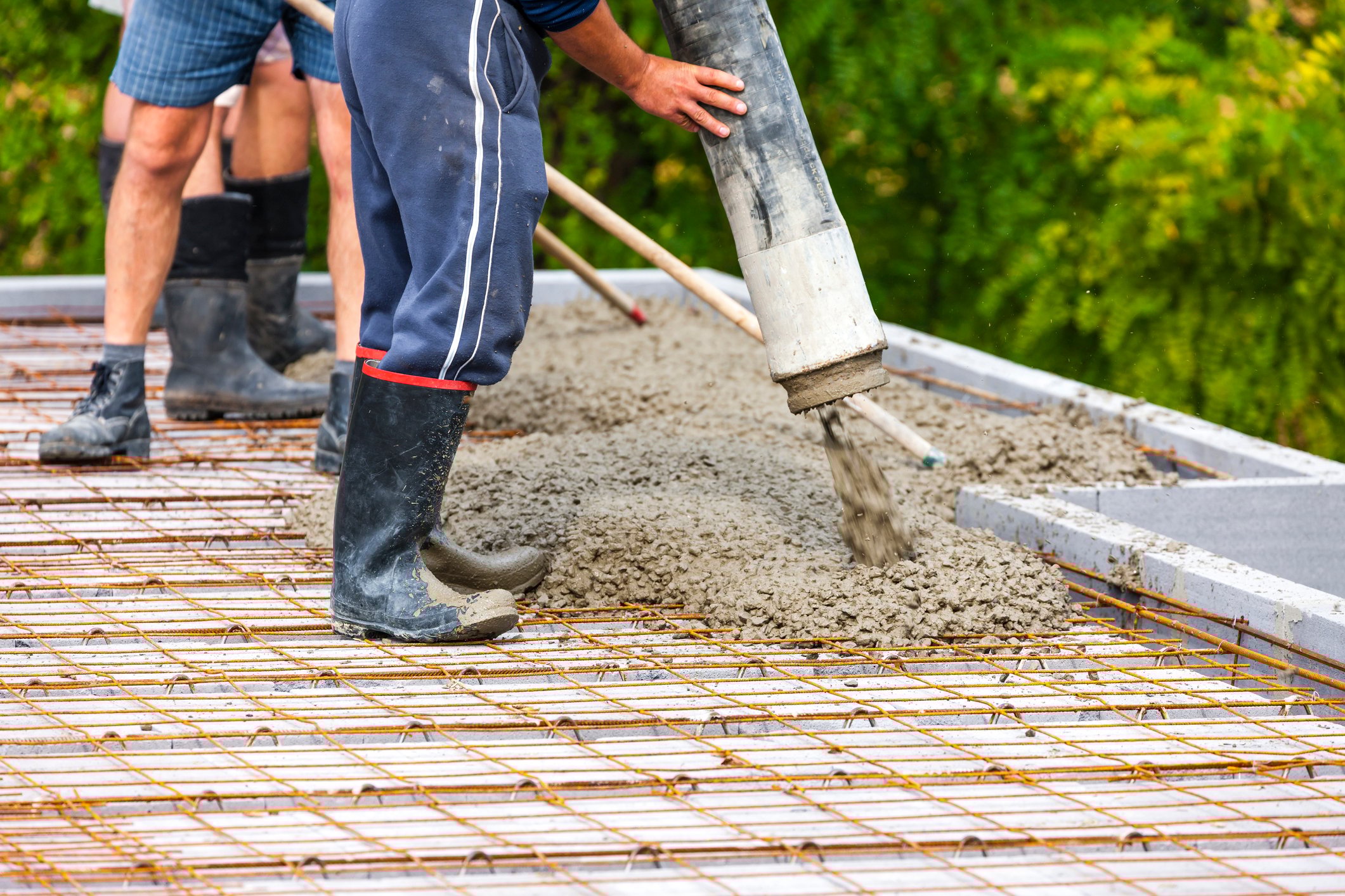 Construction workers pouring concrete.