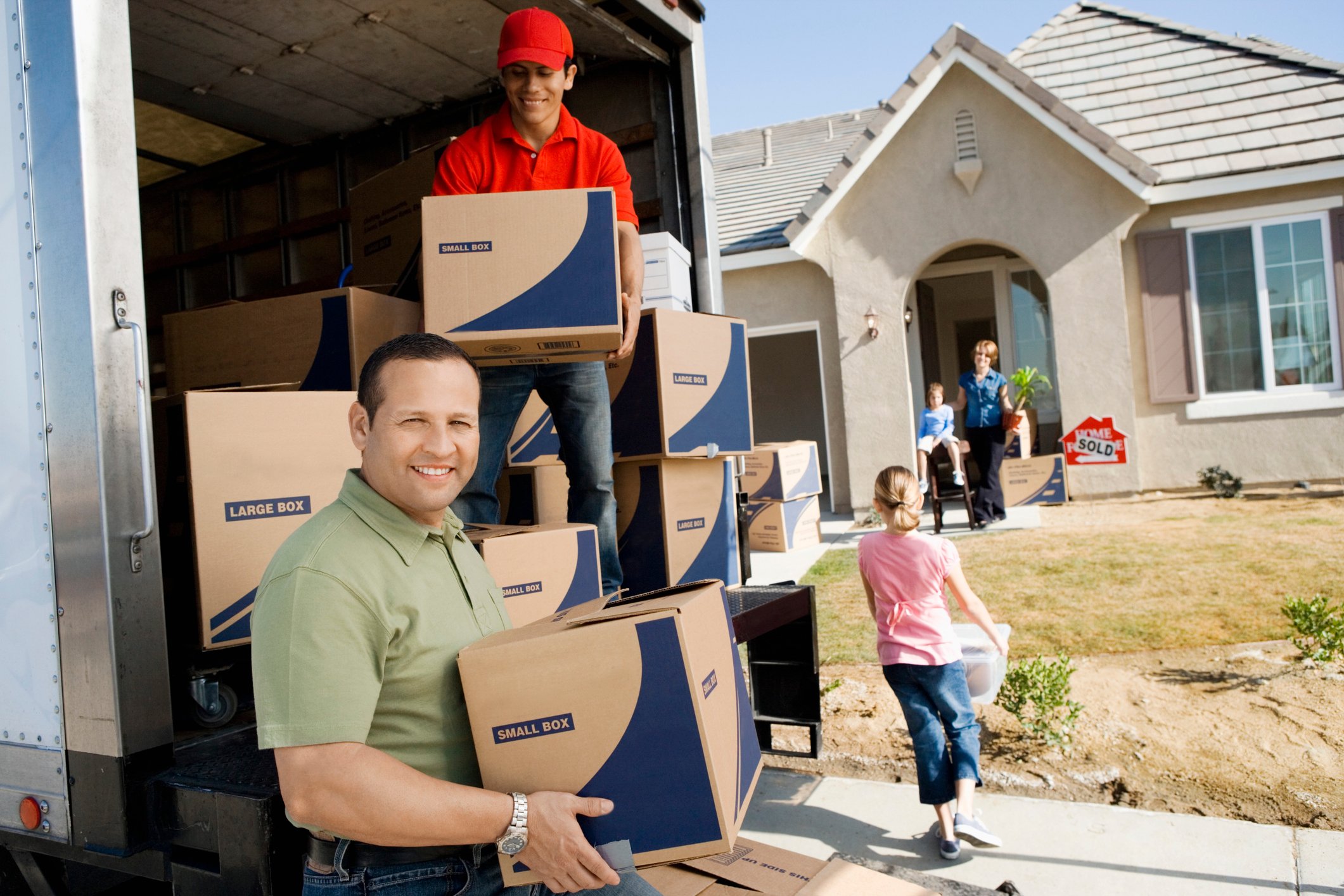 People unloading boxes from a moving truck