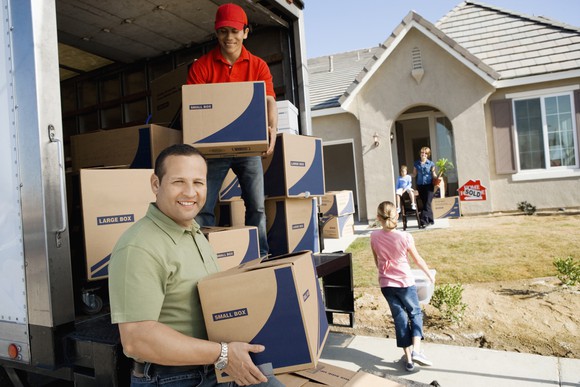 People unloading boxes from a moving truck