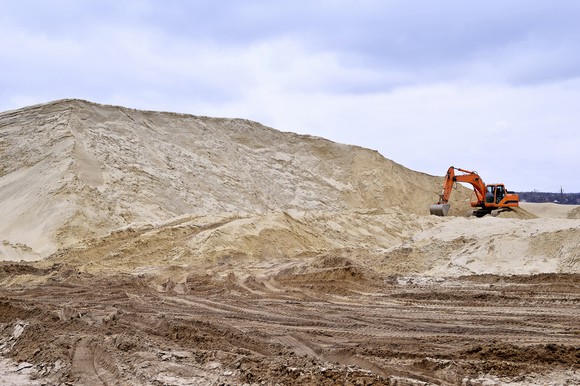 Excavator in sand mine