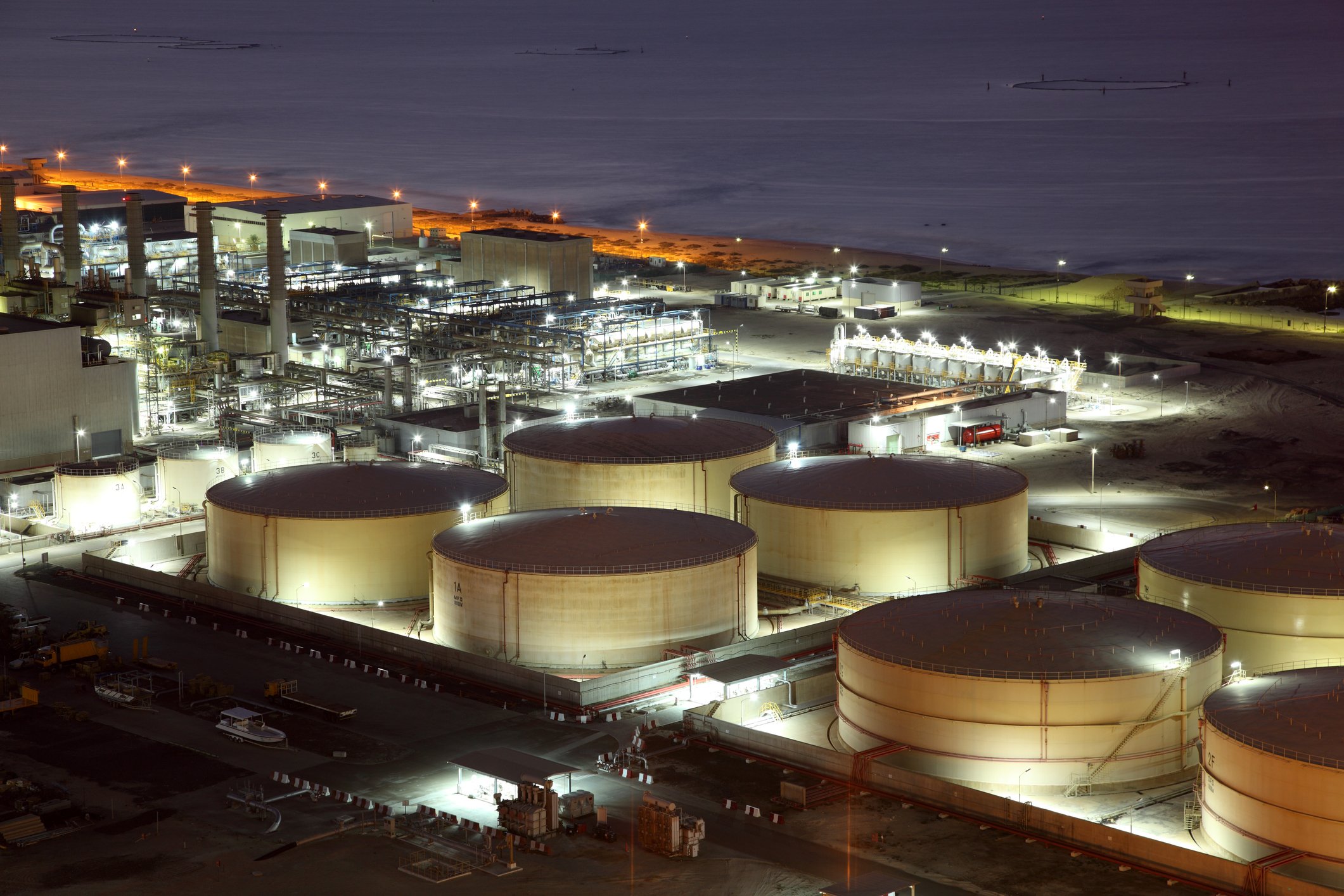 Oil refinery storage tanks at night