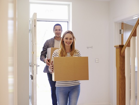 A young couple, moving into their new home. 