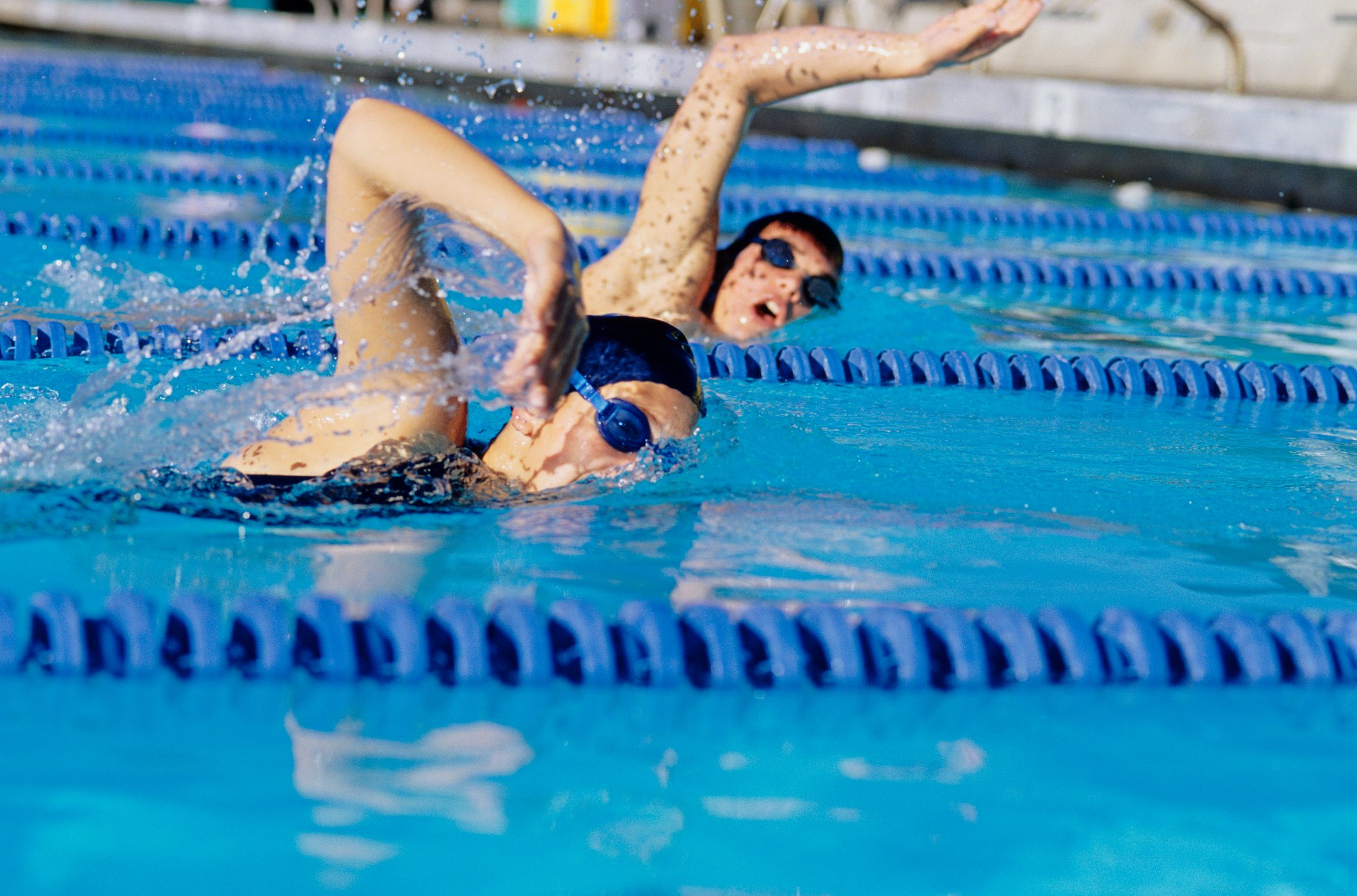Two female swimmers racing in pool