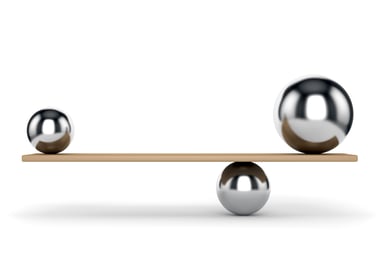 Metal balls balancing on plank