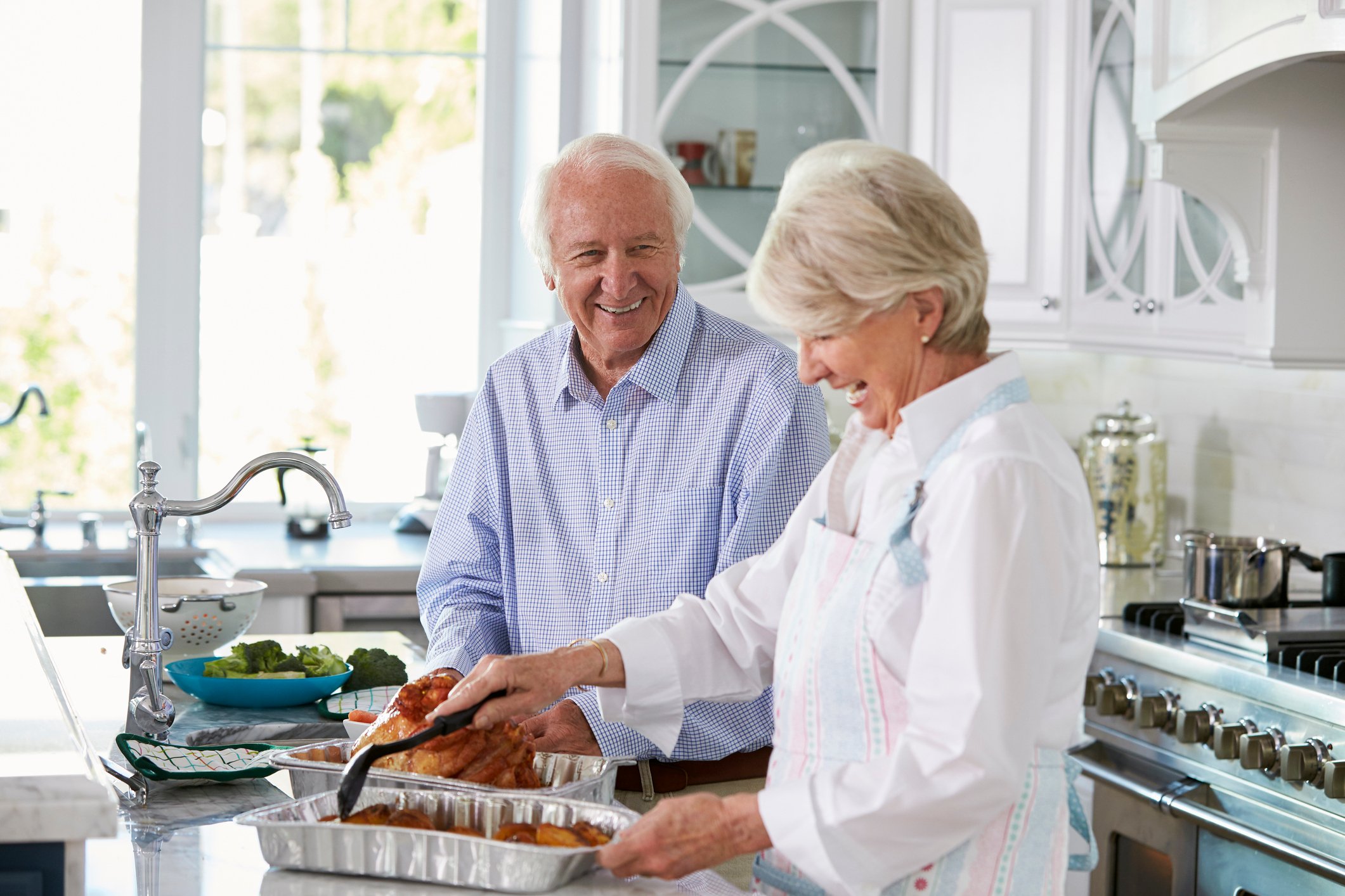 Senior couple cooking a turkey