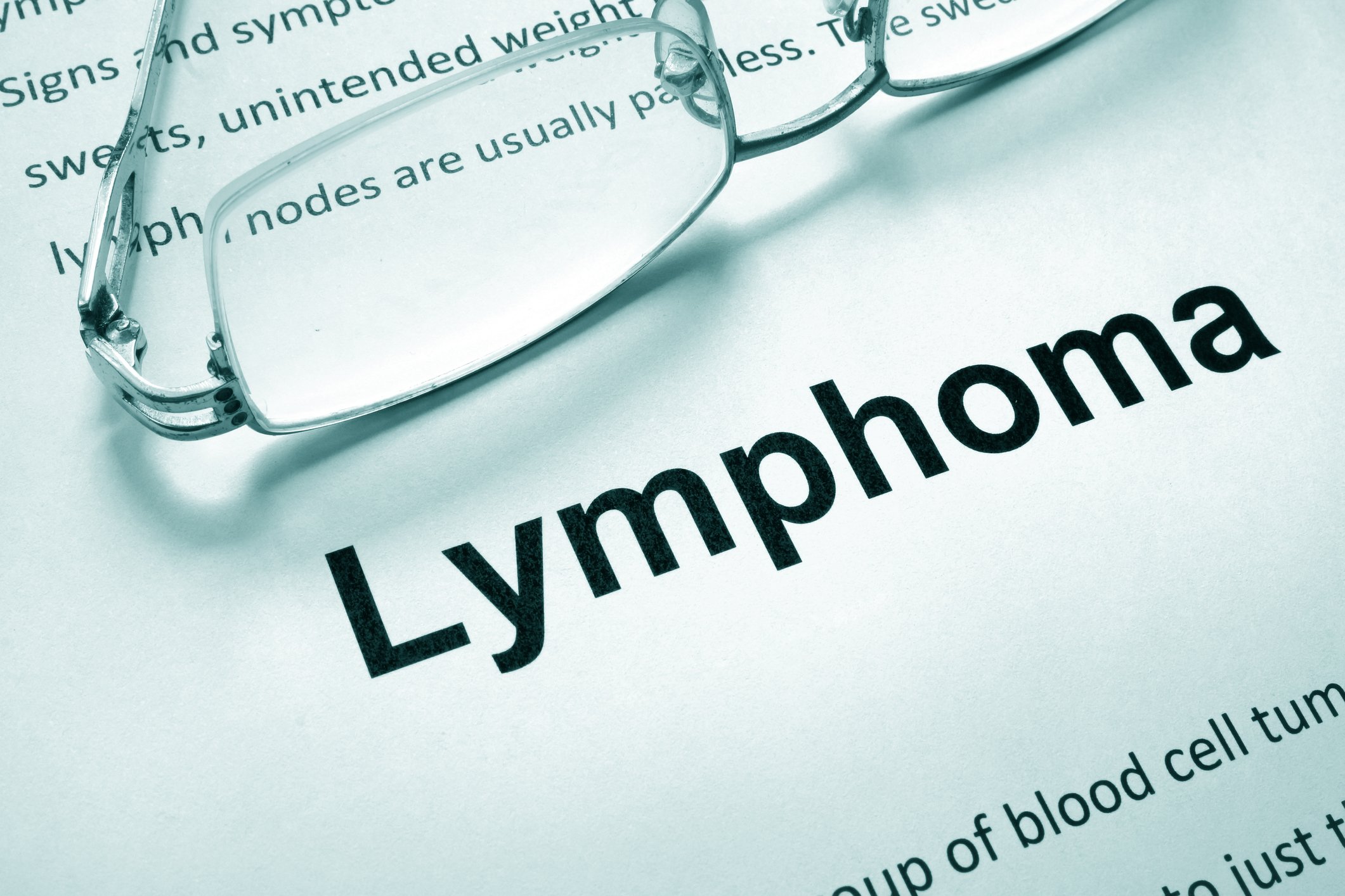 Paper with word "lymphoma" and glasses
