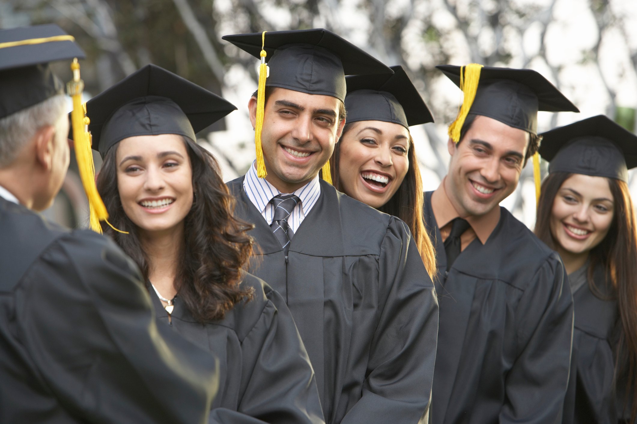 College students in graduation cap and gowns.