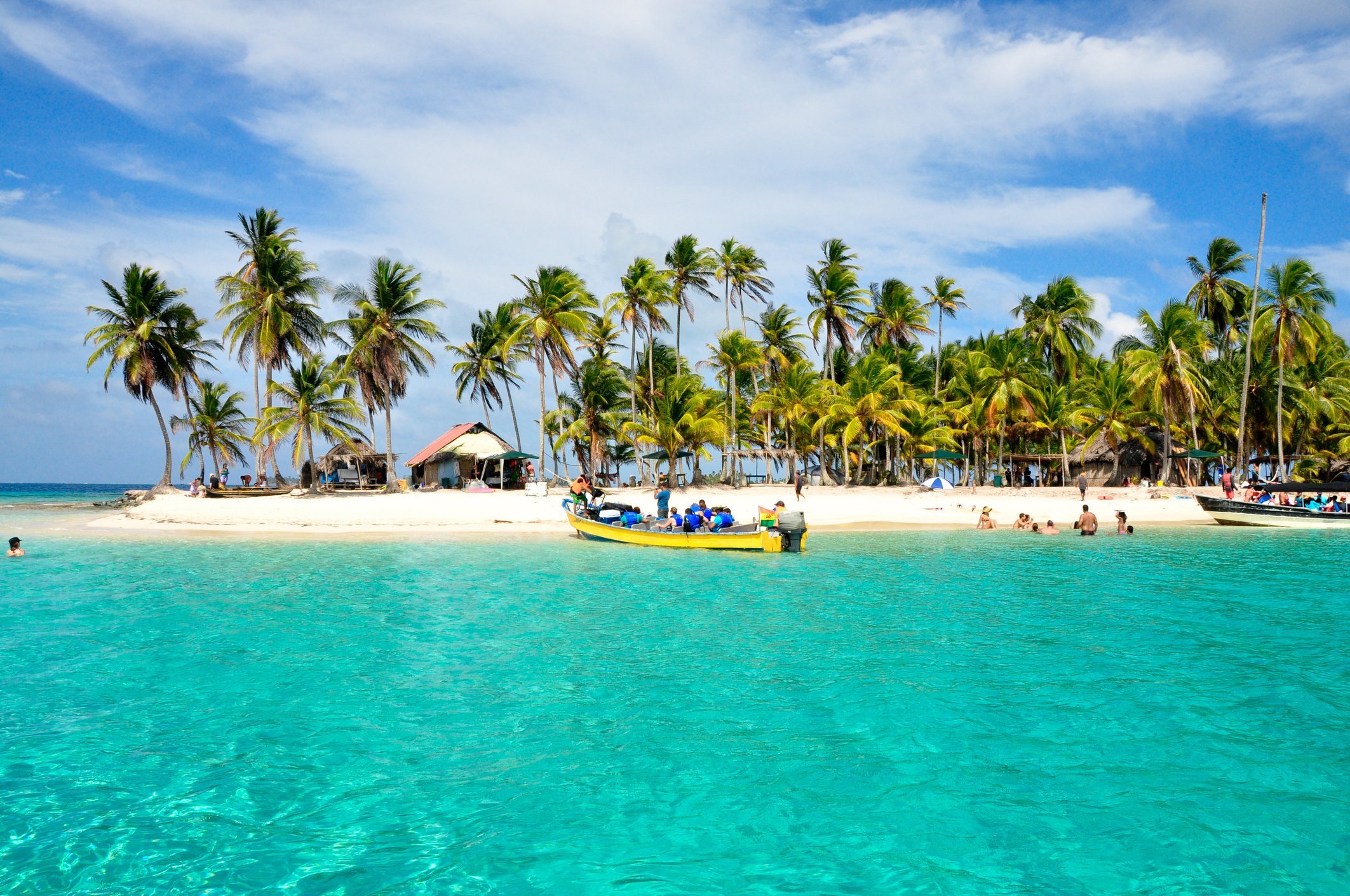 A tropical island surrounded by white sand beaches and blue-green water.