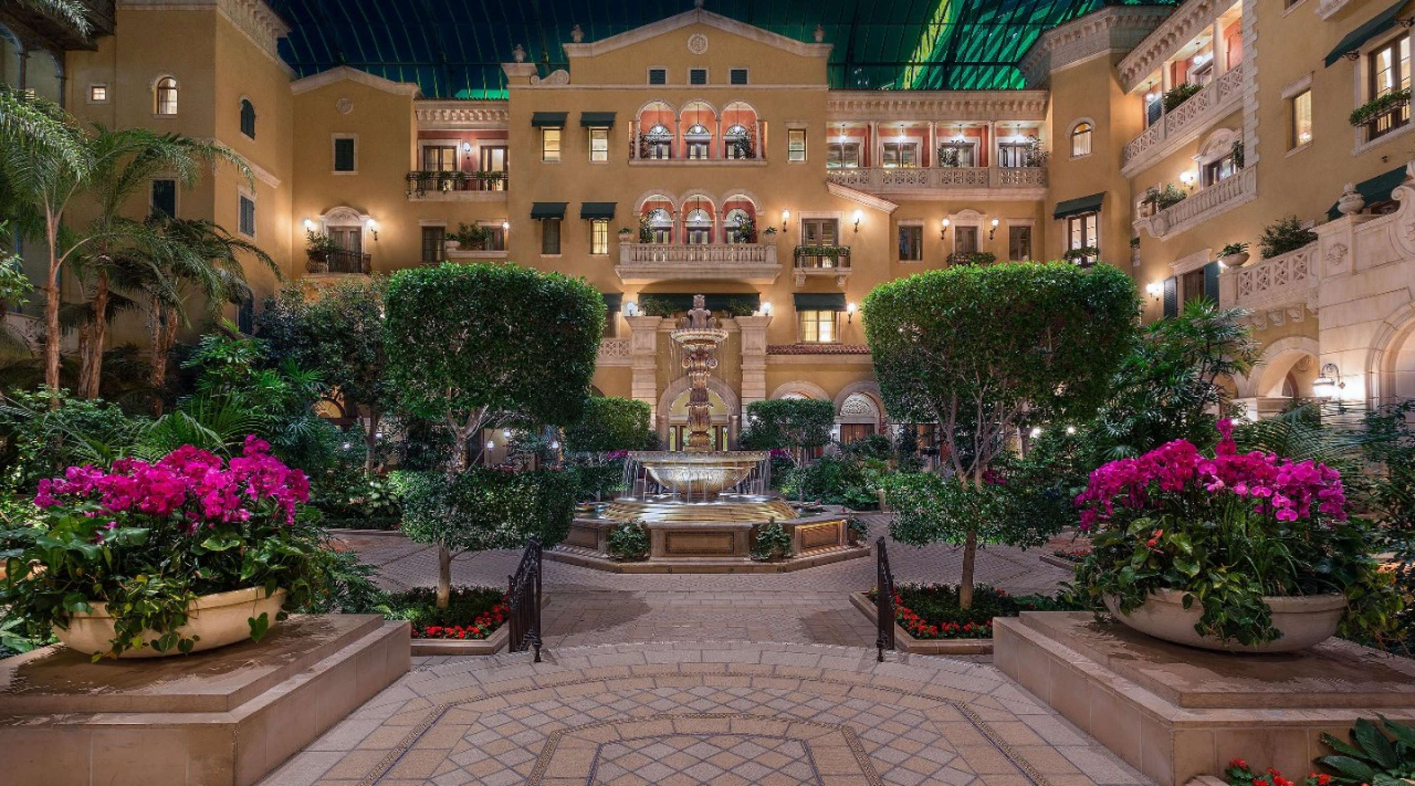 A gated entrance leading into a Tuscany-inspired set of Villas. 