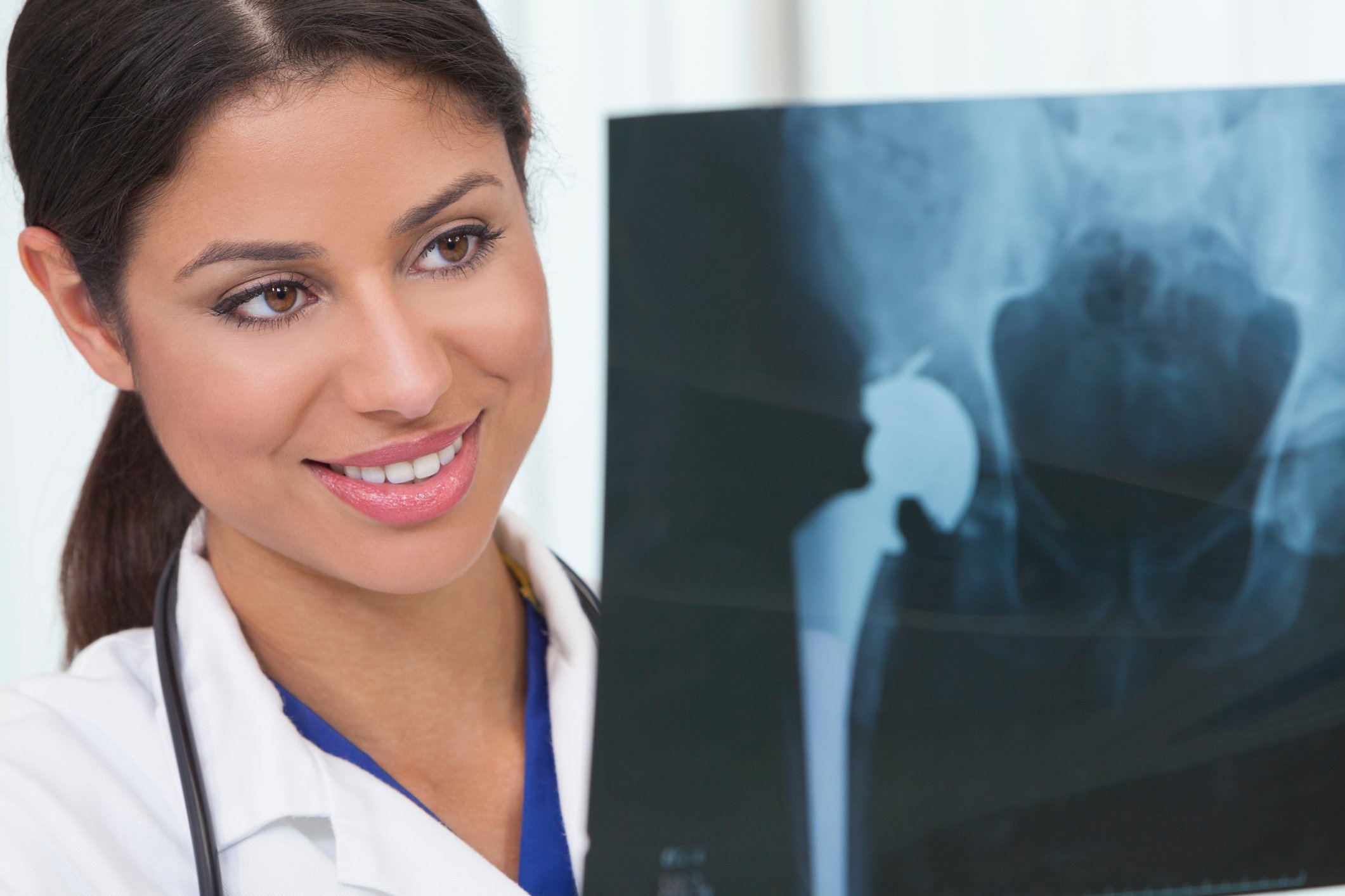 Doctor examining hip replacement X-ray.