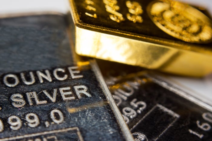 Gold and silver bars stacked next to each other. 